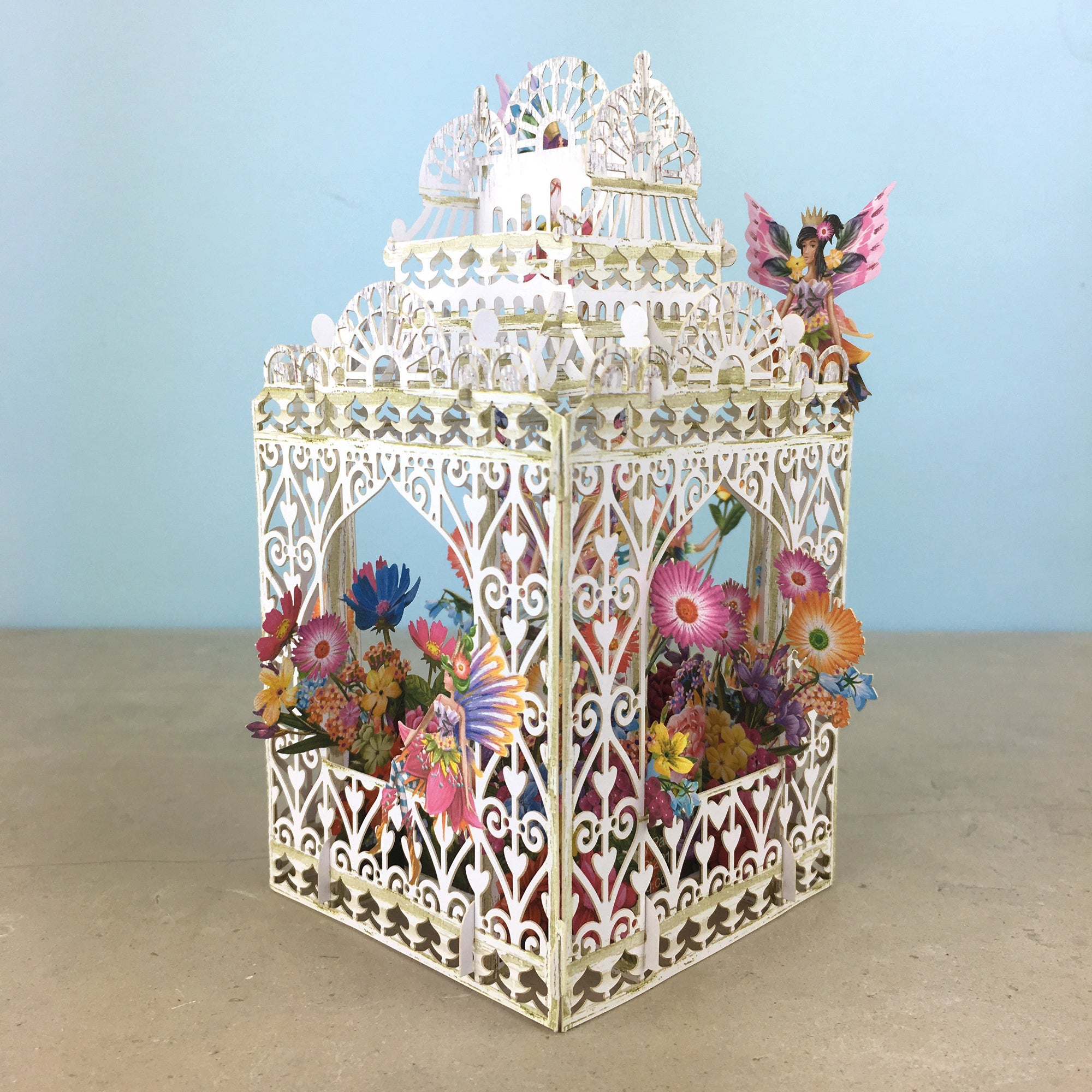 Flower Fairies play amongst flowers in laser cut paper birdcage by Me&amp;McQ